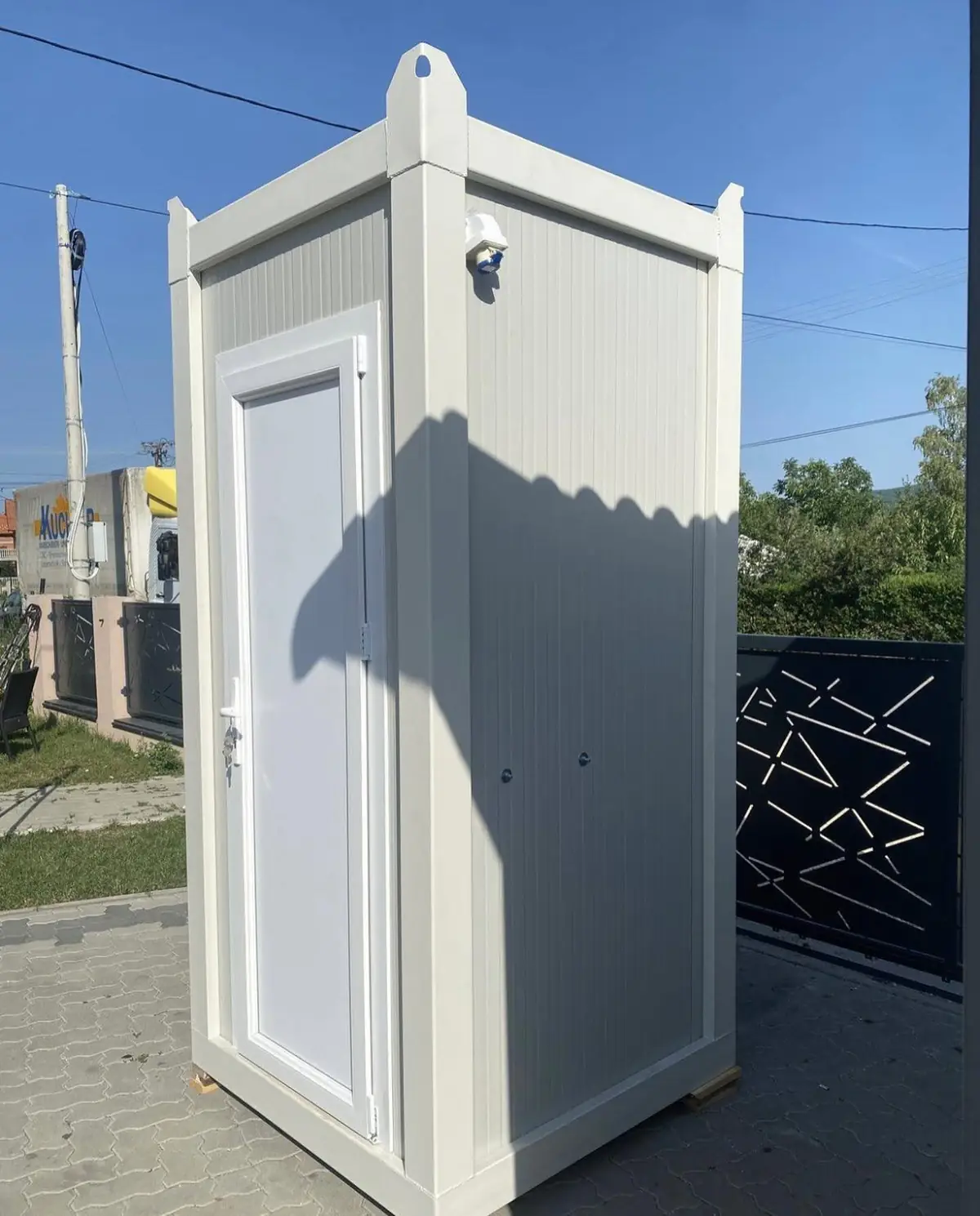 White flushing restroom cabin with a single door